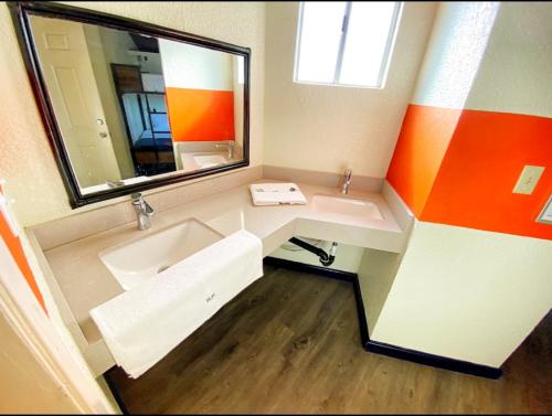 a bathroom with a sink and a mirror at Paris Hostel in Tijuana
