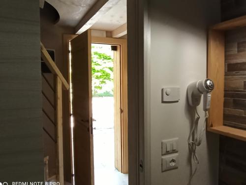 a room with a hair dryer hanging on the wall at Botte Verticale Civ.80 in Santa Maria di Piave