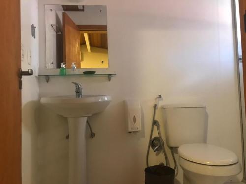 a bathroom with a white toilet and a sink at Apartamentos Sulla Collina Centro de Gramado localizado próximo da rua Coberta in Gramado