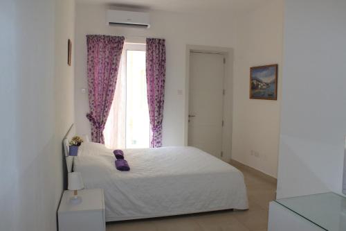 Ένα ή περισσότερα κρεβάτια σε δωμάτιο στο Il-Qastna Holiday House
