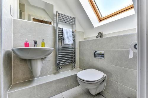 a bathroom with a toilet and a sink at London Heathrow Living Holywell Serviced Houses - 3 and 4 bedrooms By Ferndale in Stanwell