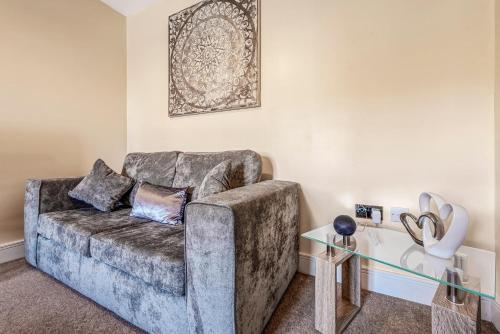 a living room with a couch and a glass table at London Heathrow Living Holywell Serviced Houses - 3 and 4 bedrooms By Ferndale in Stanwell