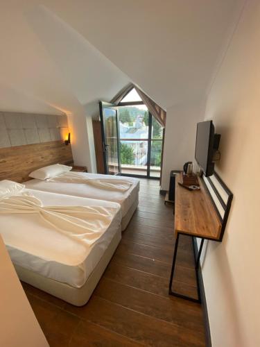 a hotel room with two beds and a television at MİYAS LUXURY HOTEL in Kemer