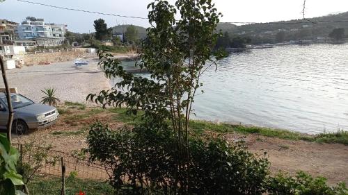 a car parked next to a body of water at Mustafaraj Apartments Ksamil in Ksamil