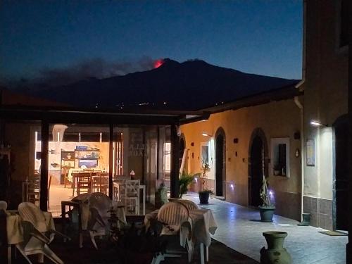 a view of a building with a mountain in the background at Villa Laura Apartment in Giardini Naxos