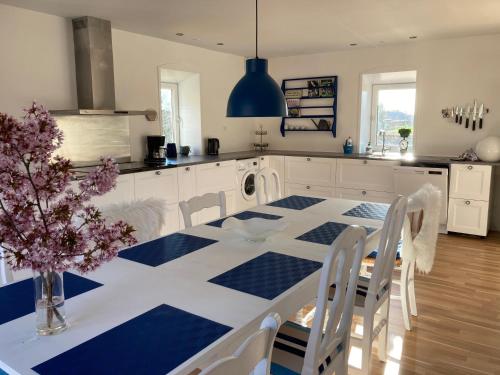 a kitchen with a blue and white table and chairs at Topagergaard in Bredsten