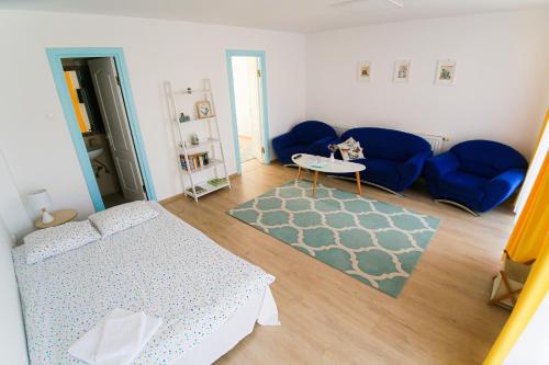 a living room with a bed and a couch at Capra Vecinului in Târgu-Mureş
