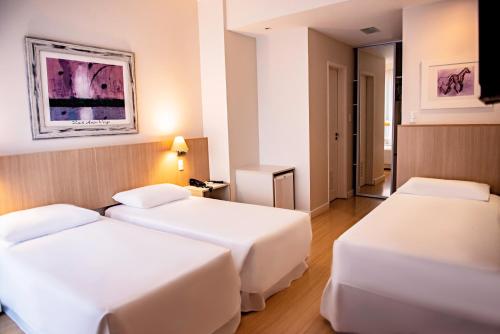 Un pat sau paturi într-o cameră la Charrua Hotel