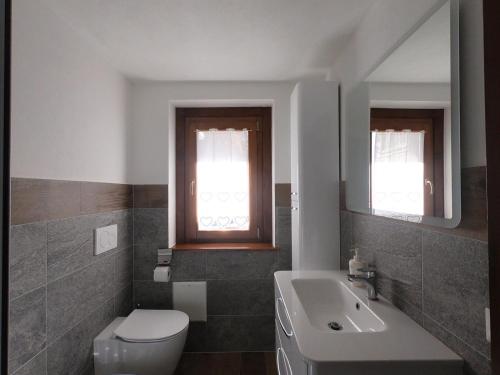 ヴァルトゥルナンシュにあるFurggenの白いトイレと洗面台のあるバスルーム