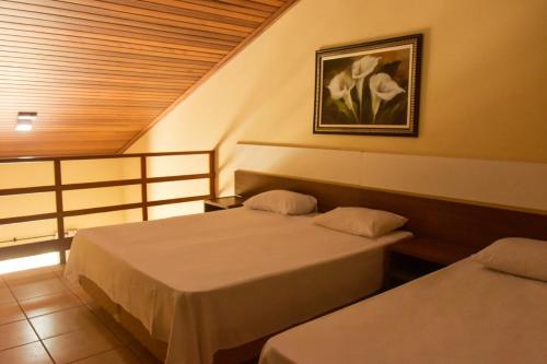 Postel nebo postele na pokoji v ubytování Rancharia Park Hotel