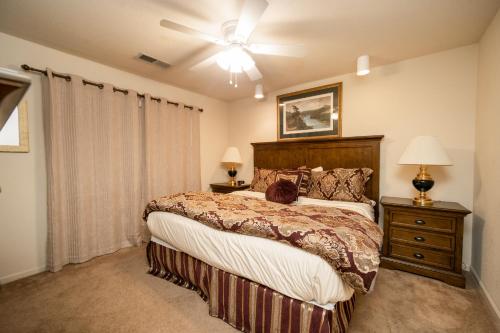 a bedroom with a large bed and a ceiling fan at Pointe Royale Golf Resort in Branson