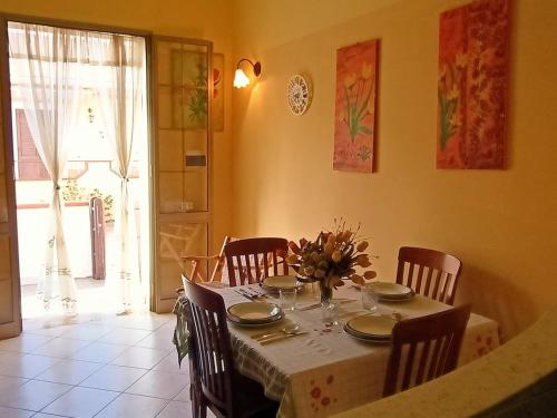 a dining room with a table with chairs and a tableablish at Mediterraneo Appartaments in Lampedusa