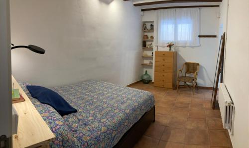 a bedroom with a bed and a desk and a chair at Cal Pere de L'Onclet in Montblanc