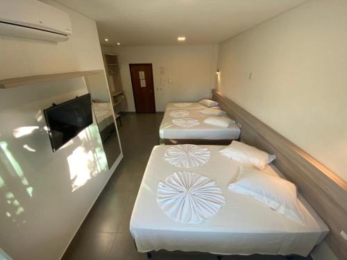 Postel nebo postele na pokoji v ubytování Hotel e Pousada Manguinho