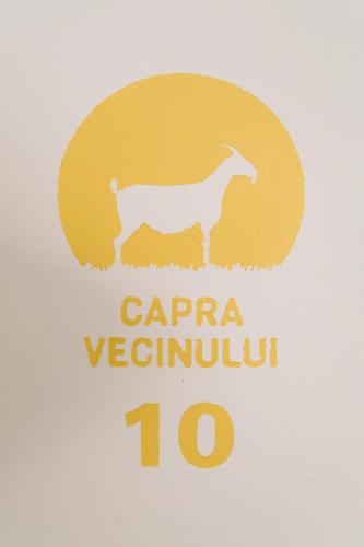 a sign with a picture of a goat on it at Capra Vecinului in Târgu-Mureş