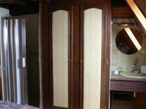 a bathroom with three glass doors and a sink at Residence 3 Chateaux in Ribeauvillé