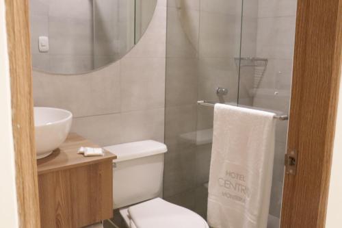 a bathroom with a toilet and a sink and a shower at Hotel Centro Monteria in Montería