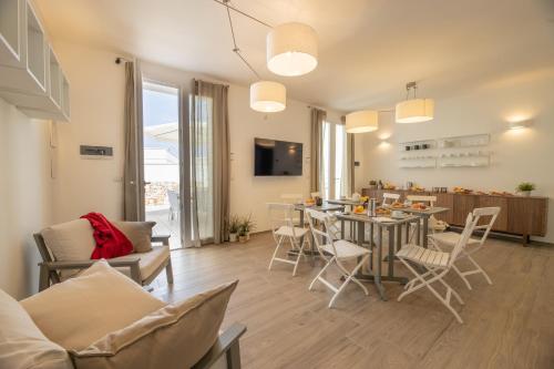 a living room with a table and chairs at B&BLeucaineout in Leuca