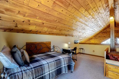a bedroom with a bed and a wooden ceiling at Timberline Vista in Cripple Creek