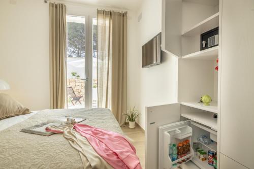 a bedroom with a bed and a window at B&BLeucaineout in Leuca