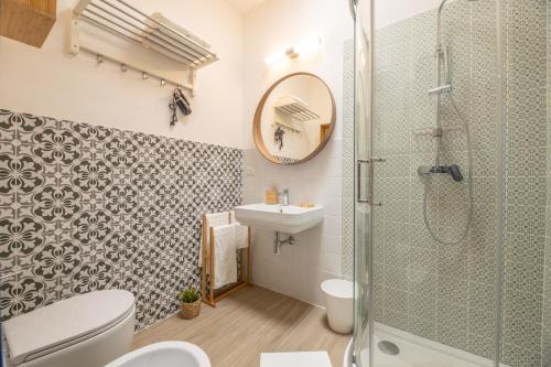 a bathroom with a shower and a toilet and a sink at B&BLeucaineout in Leuca