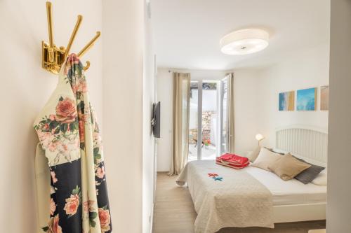 a white bedroom with a bed and a window at B&BLeucaineout in Leuca