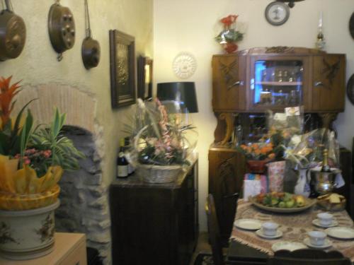 a room with a table and a cabinet with plants at Maison de la Loire in La Charité-sur-Loire