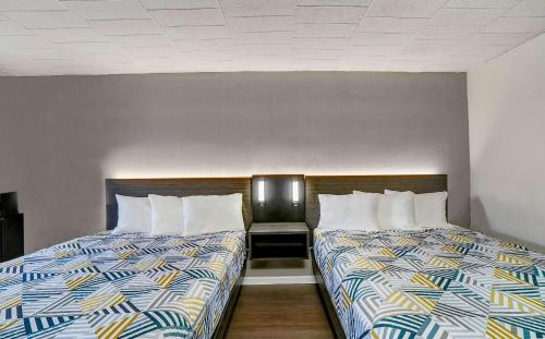 two beds sitting next to each other in a room at Motel 6 Carlisle, PA - Cumberland Valley in Carlisle