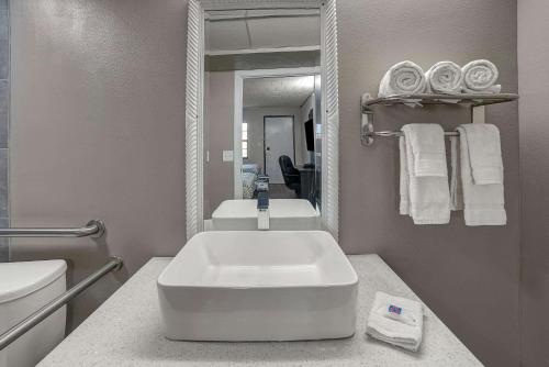 a bathroom with a white sink and a mirror at Motel 6 Carlisle, PA - Cumberland Valley in Carlisle