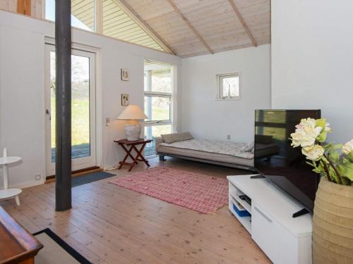 a living room with a couch and a table at Three-Bedroom Holiday home in Knebel 19 in Knebel