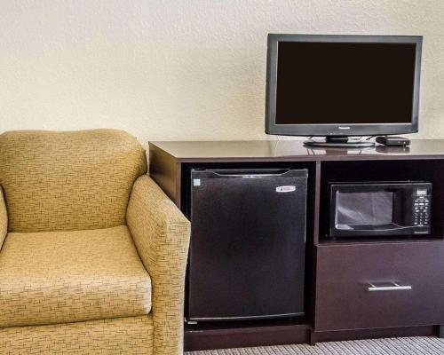 a room with a chair and a tv and a microwave at Sleep Inn Louisville Airport & Expo in Louisville