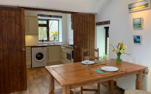 a kitchen with a wooden table and a sink at Gallery Cottage in Aberdeen
