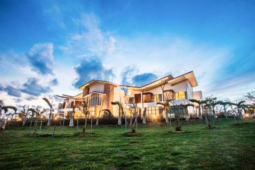 a large house with palm trees in front of it at SkyeBay Club in Hengchun