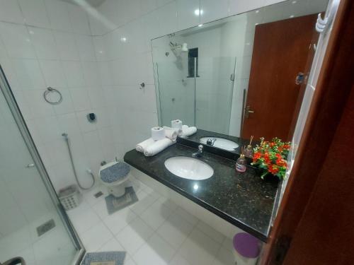 a bathroom with a sink and a mirror at loft Prainha in Arraial do Cabo