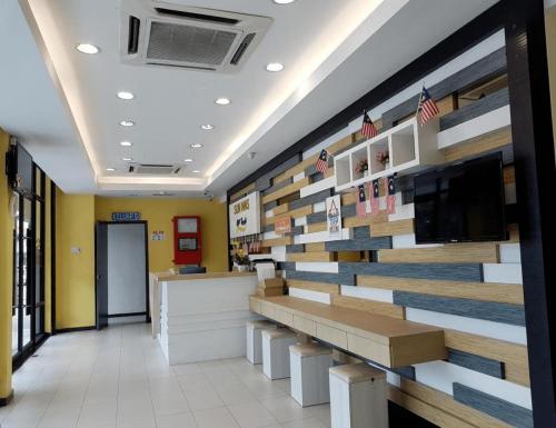 a lobby of a store with a wall made of wood at Sun Inns Hotel Ayer Keroh in Ayer Keroh