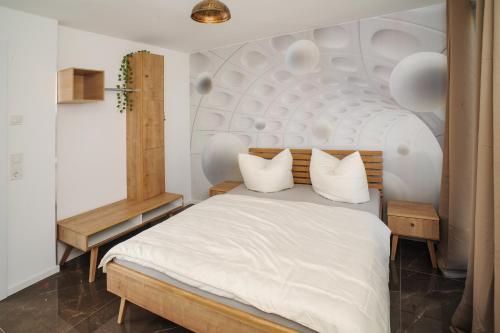 a bedroom with a large white bed with white pillows at Designapartments Sweet Home - Sennhütte 11 in Wernigerode