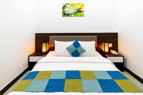 a bedroom with a bed with a colorful blanket at Phuc Thanh Luxury Hotel by THG in Da Nang