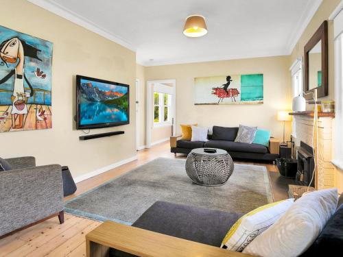 a living room with a couch and a table at Kilcunda Coast House in Woolamai