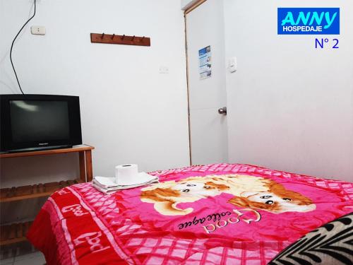 Ένα ή περισσότερα κρεβάτια σε δωμάτιο στο Hospedaje Anny