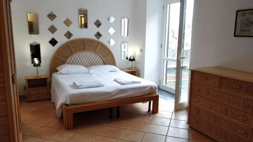 a bedroom with a large bed with a wooden headboard at Appartamenti Magnolia in Positano