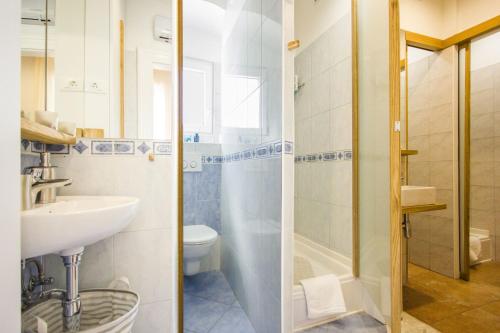 ein Bad mit einem Waschbecken, einem WC und einer Dusche in der Unterkunft Argentum Luxury Apartment in Split
