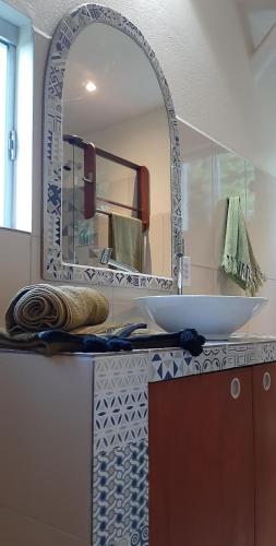 a bathroom with a sink and a mirror at Recanto Flor Da Vida - Vale do Capao in Vale do Capao