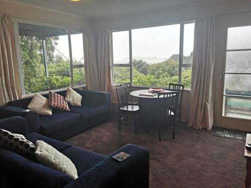 a living room with a couch and a table at Breakaway at York Bay in Days Bay