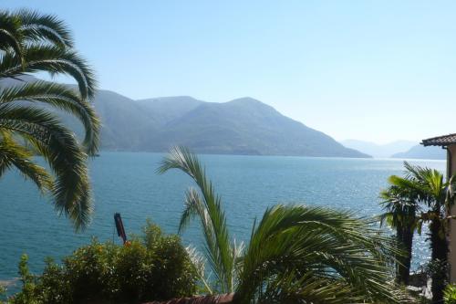 a view of a large body of water with mountains at Residenza Bettina BnB & Ferienwohnungen in Ronco s/Ascona - Porto Ronco