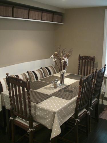 a dining room table with a polka dot table cloth at The Cavalier House B&B in Hastings
