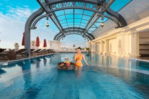 a woman in a swimming pool at a hotel at AVS Hotel Phu Quoc in Phu Quoc