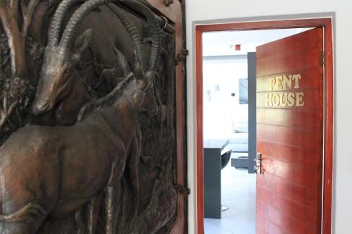 a door to a part house with a horse on it at Nelspruit Lodge in Nelspruit