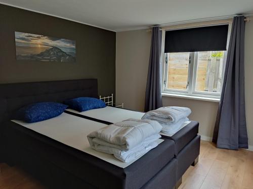 a bedroom with two beds with towels on them at Het Duintje in Scharendijke