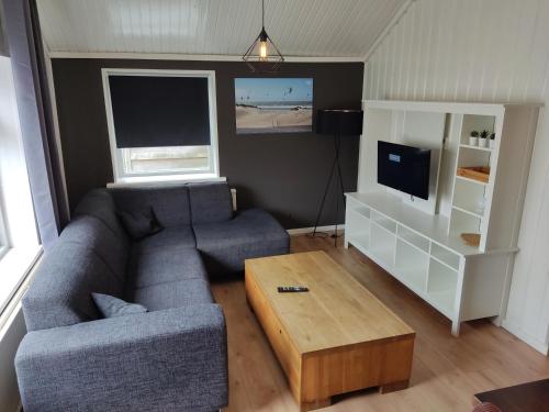a living room with a couch and a coffee table at Het Duintje in Scharendijke