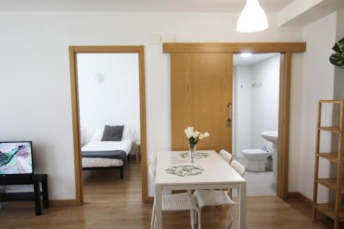 a living room with a table and a bathroom at Apartamento Labegain 6 in Sestao